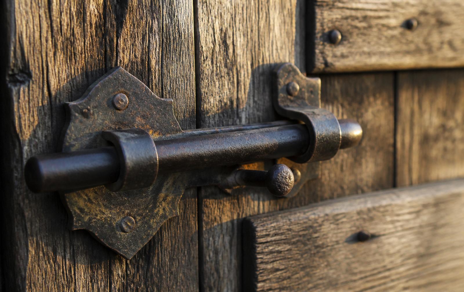 Aged brass latch on a weathered oak door